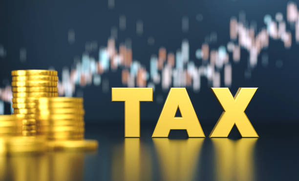 Tax With Coin Stacks Before Blue Financial Graph. Finance And Economy Concept.
